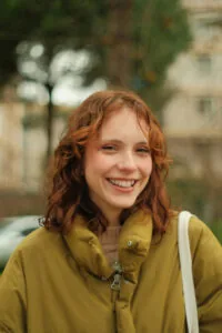 Brookville woman smiles with professionally whitened teeth while out on a walk.