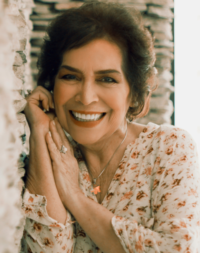 Smiling implant dentures patient in Dayton, OH poses for a photo