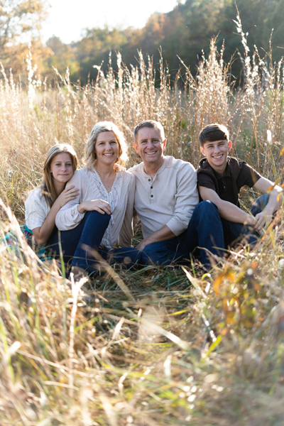Happy family with healthy teeth from Vitangeli Dental poses for a family photo outside in Dayton, OH